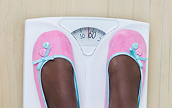 Feet in slippers on scales